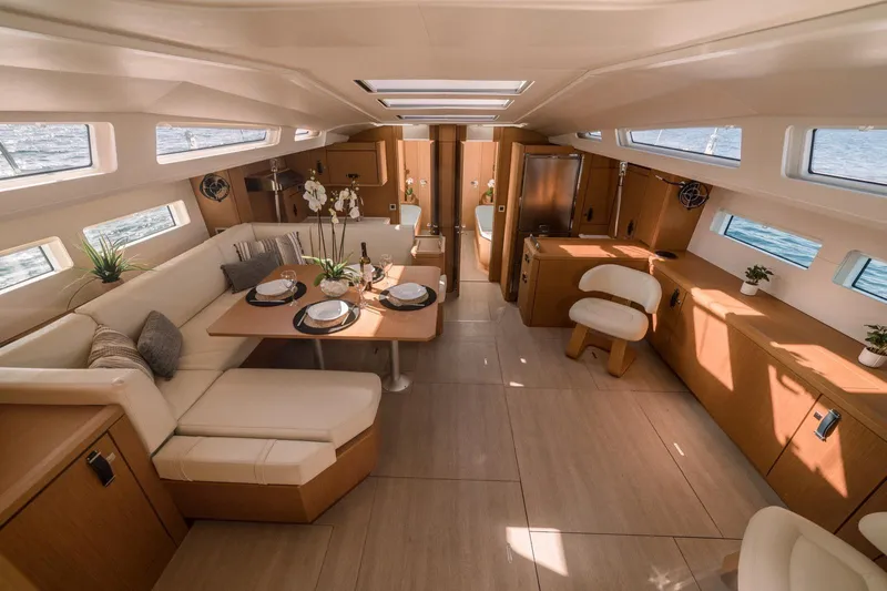 Euphoria Yacht Photos Pics Luxurious interior of 2021 Jeanneau 60 yacht with elegant dining area and modern furnishings.