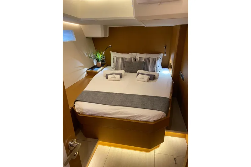 Euphoria Yacht Photos Pics Luxurious cabin interior of 2021 Jeanneau 60 yacht with cozy bed and modern decor.