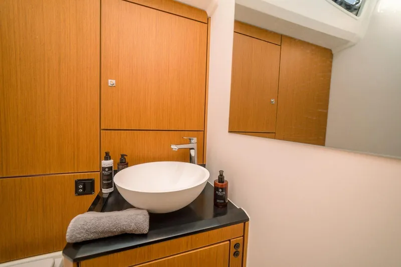 Euphoria Yacht Photos Pics Modern bathroom interior on 2021 Jeanneau 60 yacht with sleek wooden cabinetry.