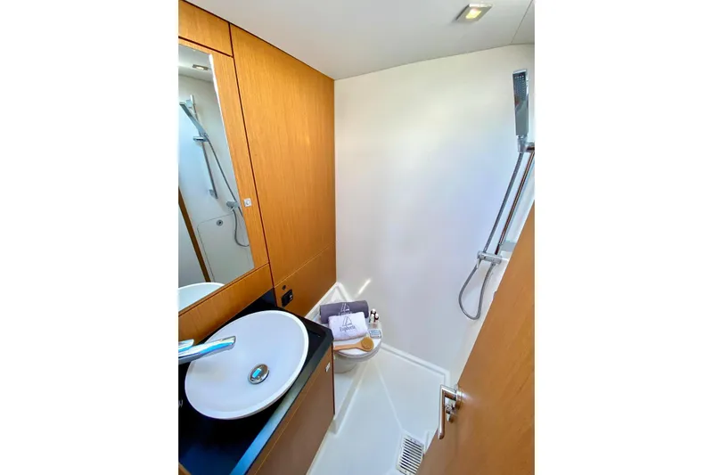 Euphoria Yacht Photos Pics Modern bathroom in 2021 Jeanneau 60 yacht with sleek fixtures and wooden cabinetry.