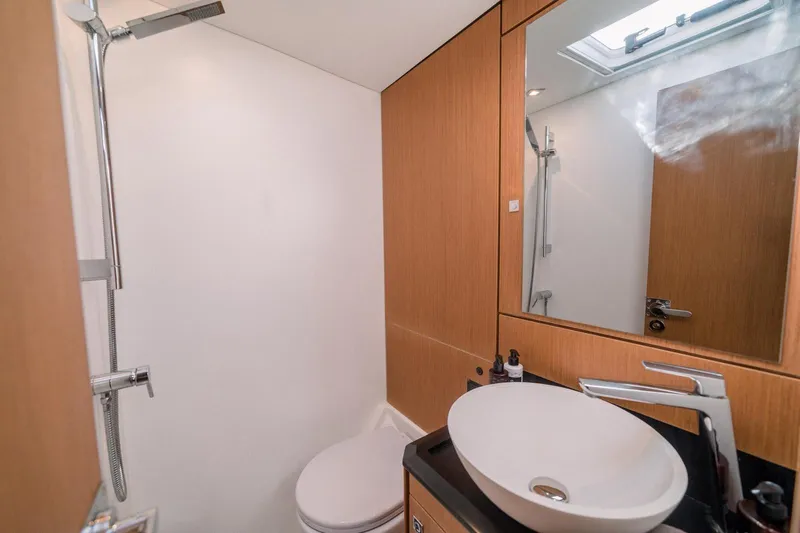 Euphoria Yacht Photos Pics Modern bathroom in 2021 Jeanneau 60 yacht with sleek fixtures and wooden accents.