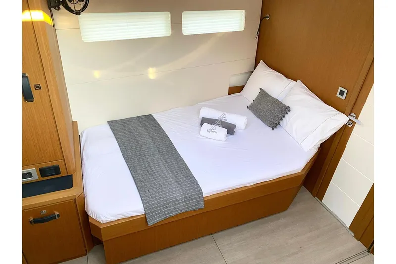 Euphoria Yacht Photos Pics Luxurious cabin interior of 2021 Jeanneau 60 yacht with cozy bed and modern design.