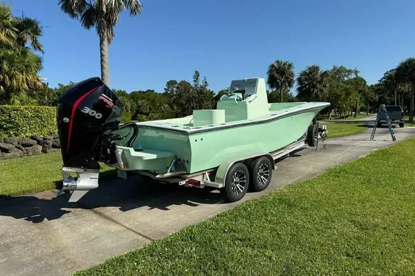 Wicked Tuna Yacht Photos Pics Custom Vernese V23 boat, 2021 model, on trailer with powerful outboard motor, parked outdoors.