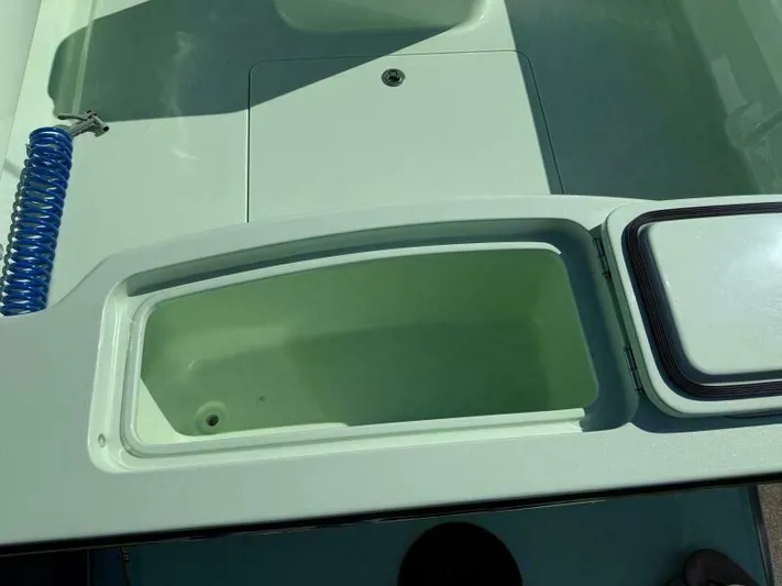 Wicked Tuna Yacht Photos Pics Open storage compartment on a 2021 Custom Vernese V23 boat, featuring a sleek design.