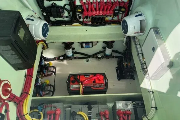 Wicked Tuna Yacht Photos Pics Engine compartment of a 2021 Custom Vernese V23, showcasing wiring and battery setup.