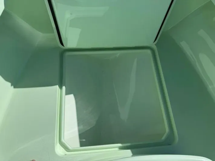 Wicked Tuna Yacht Photos Pics Open storage compartment in a 2021 Custom Vernese V23 boat.