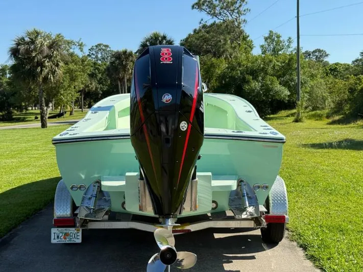 Wicked Tuna Yacht Photos Pics Custom Vernese V23 boat, 2021 model, with powerful outboard motor on a trailer in a lush setting.
