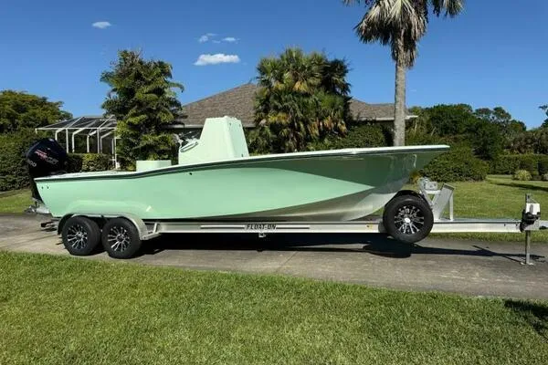 Wicked Tuna Yacht Photos Pics Custom Vernese V23 boat on trailer, parked in a lush garden setting, 2021 model.