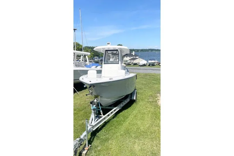 Century 2400cc Yacht Photos Pics 2022 Century 2400 Center Console boat on trailer by a lakeside.