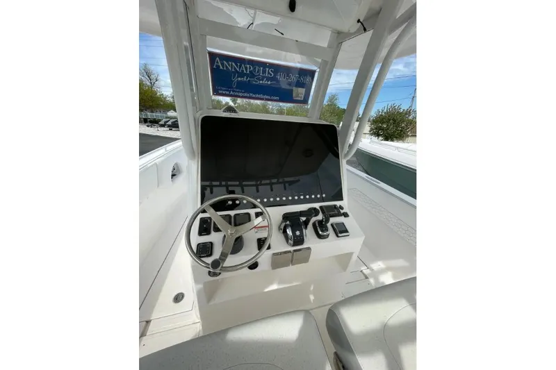 Century 2400cc Yacht Photos Pics 2022 Century 2400 Center Console boat dashboard with steering wheel and controls.