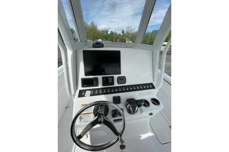 Century 2400cc Yacht Photos Pics Century 2400 Center Console 2022 dashboard with steering wheel, controls, and display screen.