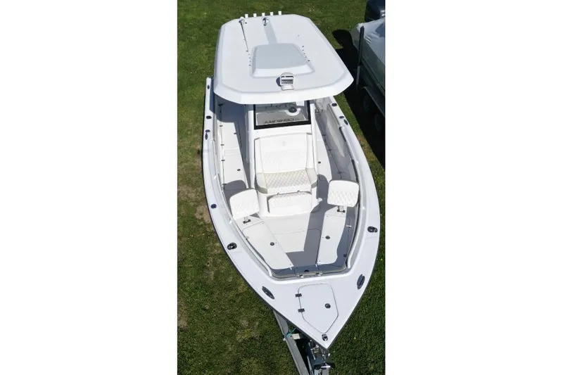 Century 2400cc Yacht Photos Pics 2022 Century 2400 Center Console boat, aerial view, white exterior, on grass.