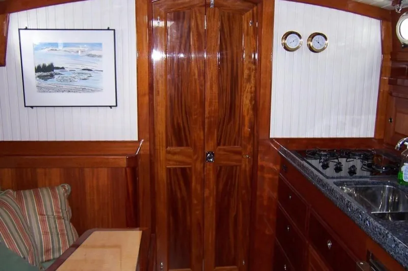 Skylark Yacht Photos Pics Interior of 2005 Lyman-Morse Monhegan yacht with wood finish and compact kitchen.
