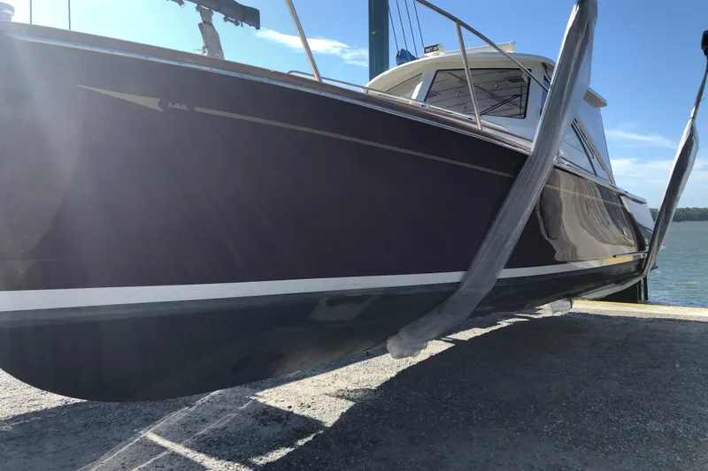 Skylark Yacht Photos Pics 2005 Lyman-Morse Monhegan boat on lift, side view with clear sky background.