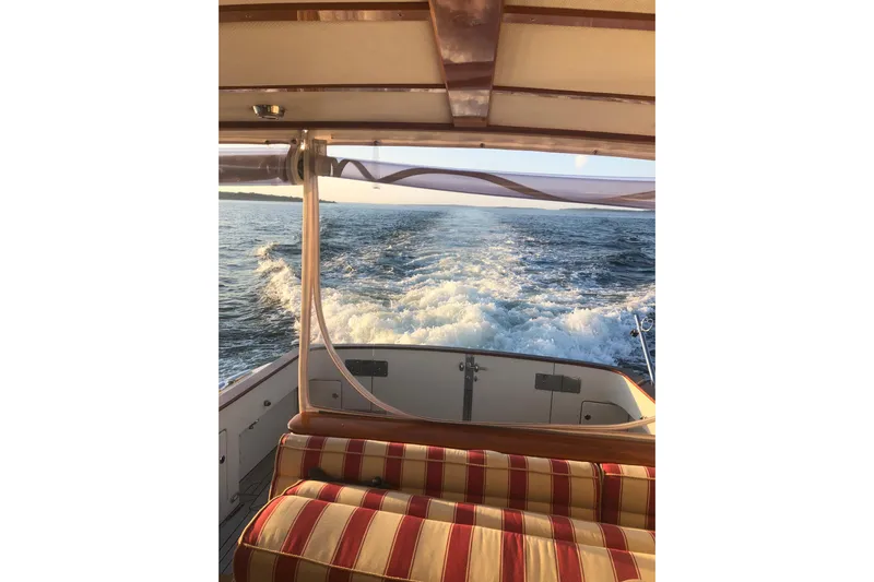 Skylark Yacht Photos Pics 2005 Lyman-Morse Monhegan boat interior with striped seating, ocean view, and wake.