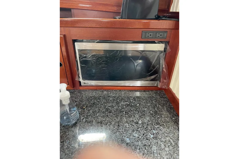 Skylark Yacht Photos Pics Built-in microwave in Lyman-Morse Monhegan 2005 yacht kitchen with granite countertop.