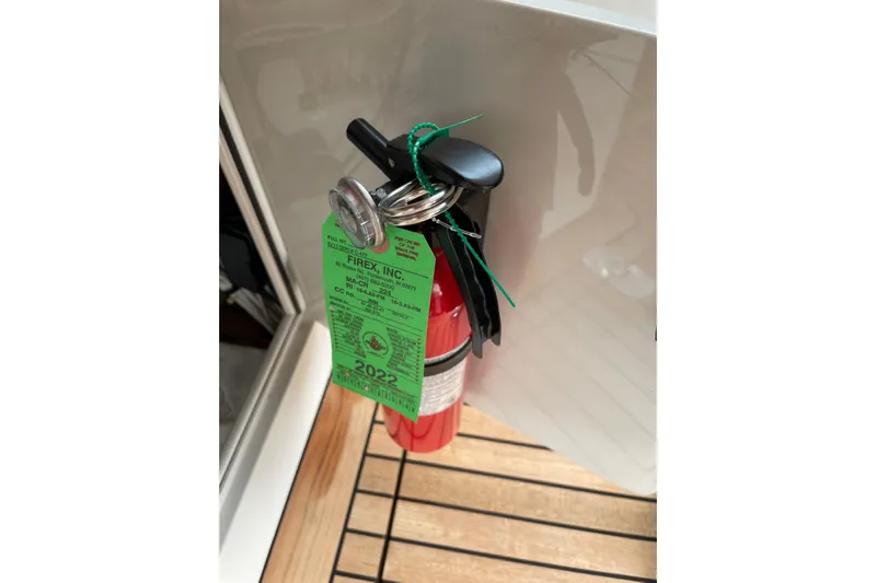 Skylark Yacht Photos Pics Red fire extinguisher with inspection tag on Lyman-Morse Monhegan 2005 boat.