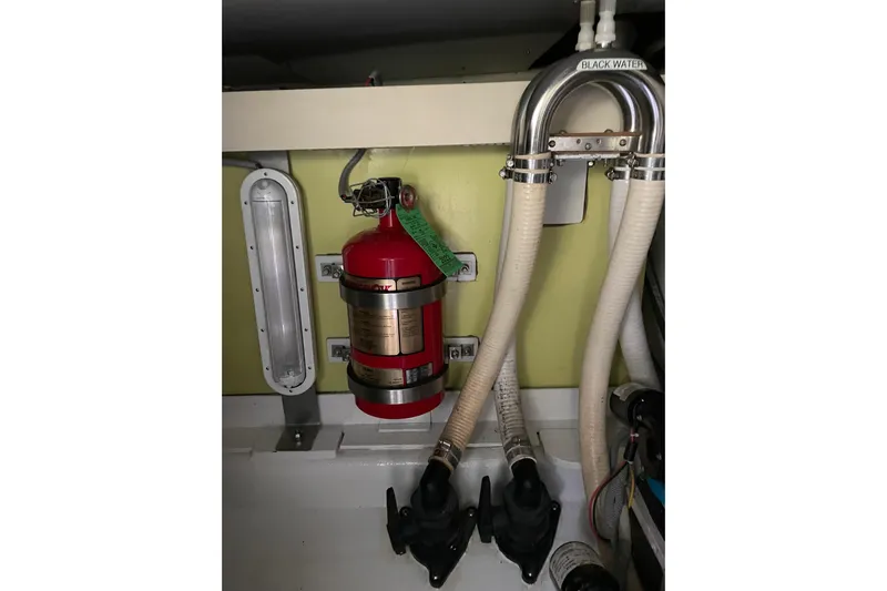 Skylark Yacht Photos Pics Engine room of 2005 Lyman-Morse Monhegan with fire extinguisher and plumbing.