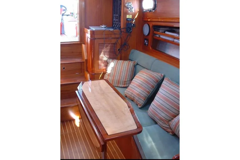 Skylark Yacht Photos Pics Interior of 2005 Lyman-Morse Monhegan yacht with wooden finish and striped cushions.