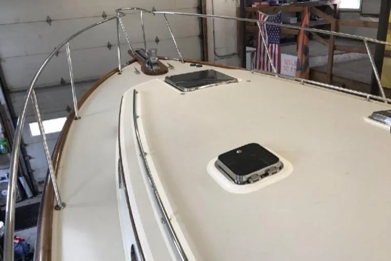 Skylark Yacht Photos Pics 2005 Lyman-Morse Monhegan yacht deck with railings and hatches in a garage setting.