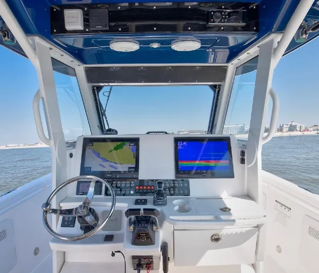 Done Diggin Yacht Photos Pics 2019 Everglades 355 Center Console boat dashboard with navigation screens and steering wheel.