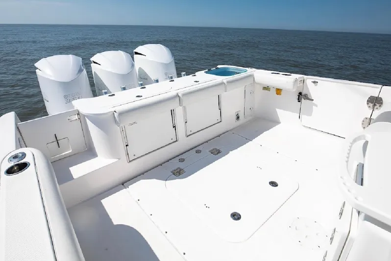 Done Diggin Yacht Photos Pics 2019 Everglades 355 Center Console boat with triple outboard engines on open sea.