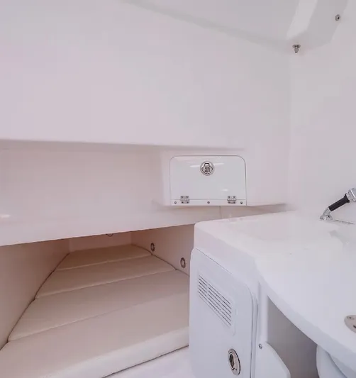 Done Diggin Yacht Photos Pics Interior cabin of 2019 Everglades 355 Center Console boat, featuring a compact sleeping area.