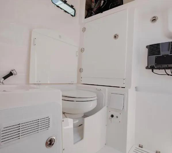 Done Diggin Yacht Photos Pics Interior of 2019 Everglades 355 Center Console boat featuring a compact marine toilet.