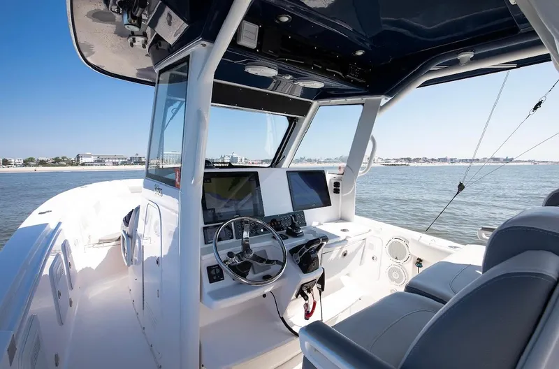 Done Diggin Yacht Photos Pics 2019 Everglades 355 Center Console boat interior with steering wheel and navigation screens.