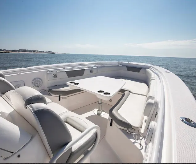 Done Diggin Yacht Photos Pics 2019 Everglades 355 Center Console boat interior with seating and table on open water.