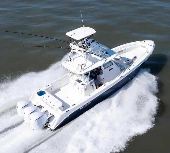 Done Diggin Yacht Photos Pics 2019 Everglades 355 Center Console boat cruising on open water, showcasing triple outboard engines.