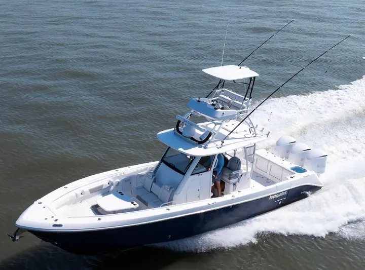 Done Diggin Yacht Photos Pics 2019 Everglades 355 Center Console boat cruising on open water.