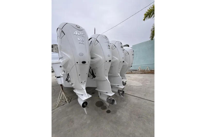  Yacht Photos Pics 2023 Regulator 41 boat with triple 425 V8 outboard engines, parked on concrete.