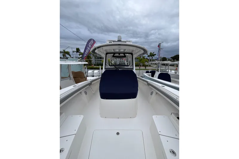  Yacht Photos Pics 2023 Regulator 41 boat with blue seating, docked under cloudy skies.