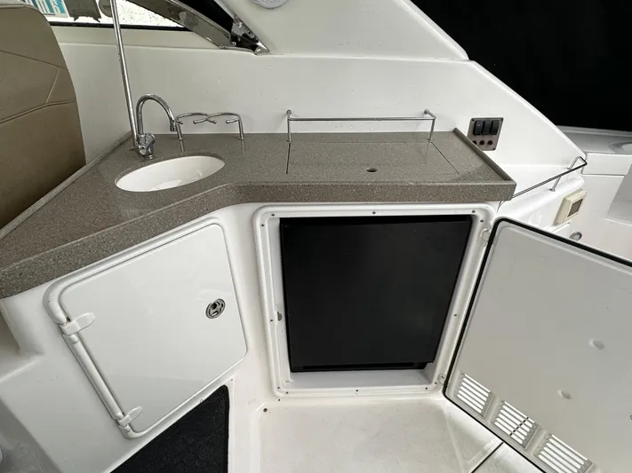 Beautify Yacht Photos Pics 2010 Regal 3760 Sportyacht kitchenette with sink, countertop, and storage compartments.
