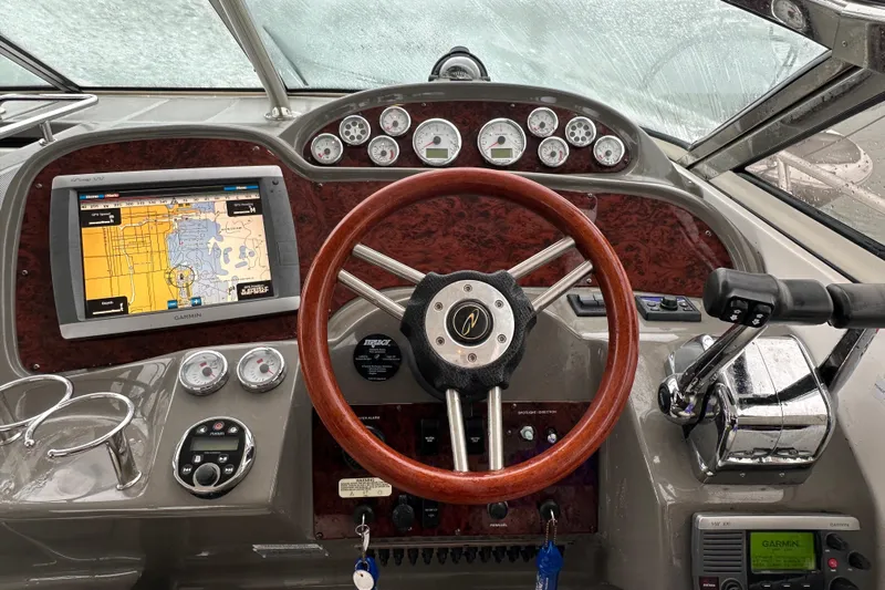 Beautify Yacht Photos Pics 2010 Regal 3760 Sportyacht helm with GPS, gauges, and wooden steering wheel.