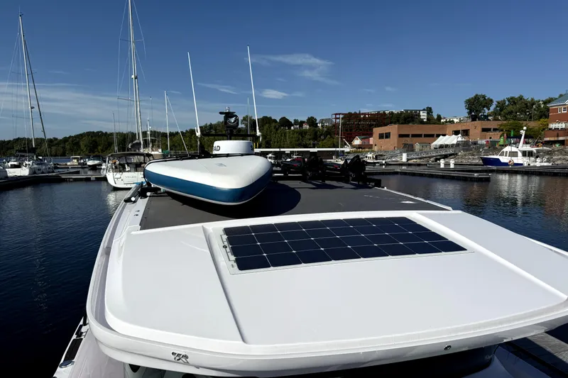  Yacht Photos Pics 2025 Axopar 37 XC CROSS CABIN with solar panel, docked in a marina under clear skies.