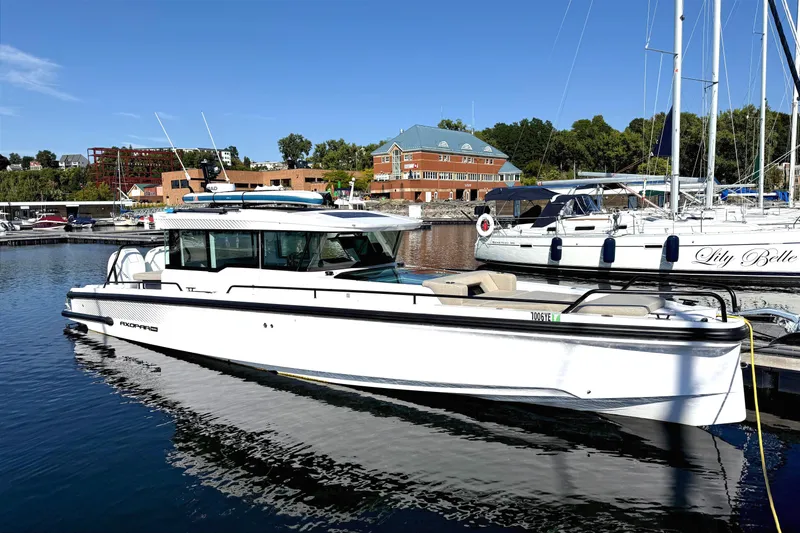  Yacht Photos Pics 2025 Axopar 37 XC CROSS CABIN boat docked in a marina under clear blue skies.