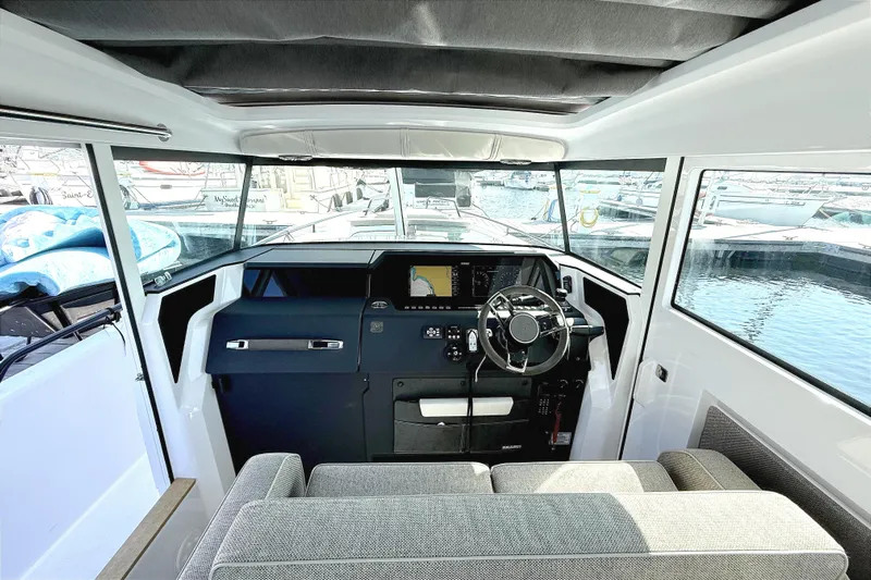  Yacht Photos Pics Interior view of 2025 Axopar 37 XC CROSS CABIN, featuring modern helm and seating.