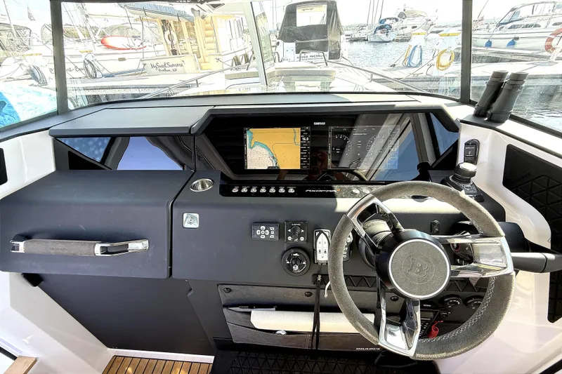  Yacht Photos Pics 2025 Axopar 37 XC CROSS CABIN helm with modern navigation system and steering wheel.