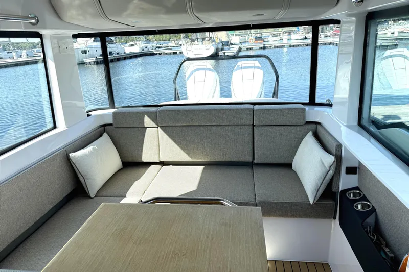  Yacht Photos Pics Interior of 2025 Axopar 37 XC CROSS CABIN with comfortable seating and marina view.