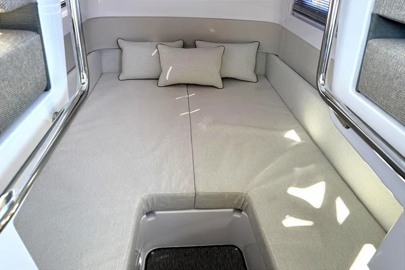 Yacht Photos Pics 2025 Axopar 37 XC CROSS CABIN interior with cozy bed and cushions.