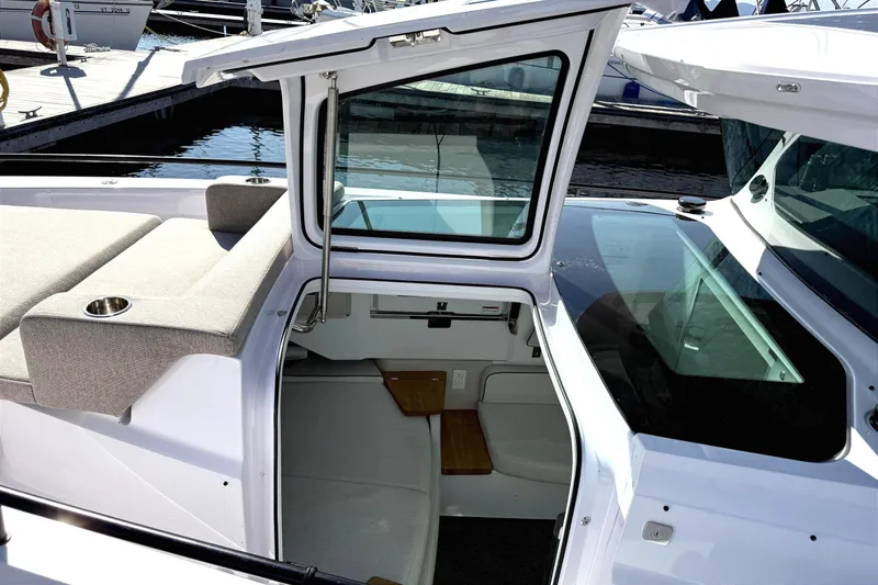  Yacht Photos Pics 2025 Axopar 37 XC CROSS CABIN boat interior with open cabin door and seating area.