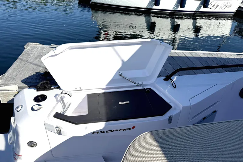  Yacht Photos Pics Open storage compartment on 2025 Axopar 37 XC CROSS CABIN boat at dockside.