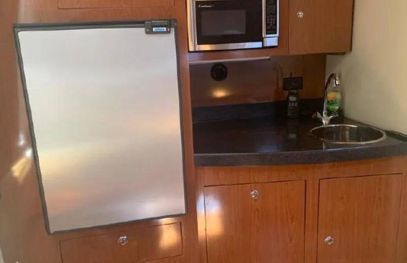 Beautify Yacht Photos Pics Kitchen area of 2010 Regal 3760 Sportyacht with fridge, microwave, and sink.