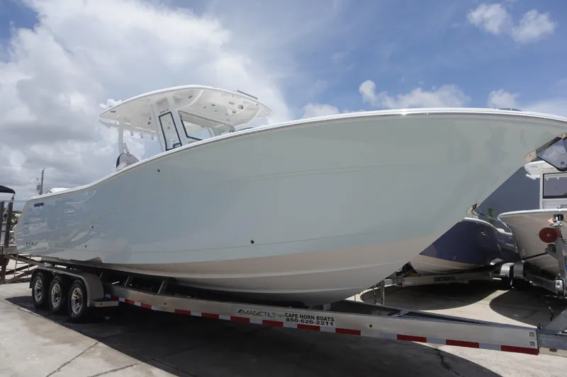  Yacht Photos Pics 2025 Sea Fox 328 Commander boat on a trailer under a cloudy sky.