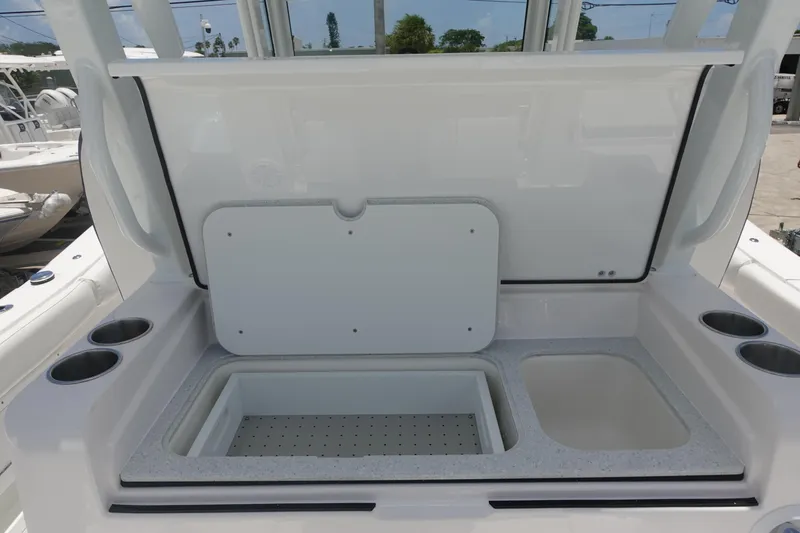  Yacht Photos Pics 2025 Sea Fox 328 Commander boat storage compartment with open lid and cup holders.