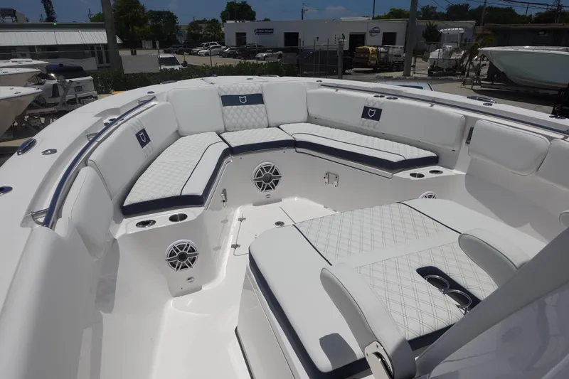  Yacht Photos Pics 2025 Sea Fox 328 Commander boat interior with white cushioned seating and speakers.
