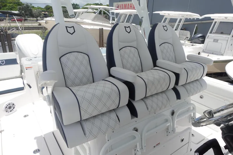  Yacht Photos Pics Luxury seating on 2025 Sea Fox 328 Commander boat, featuring elegant white and black upholstery.