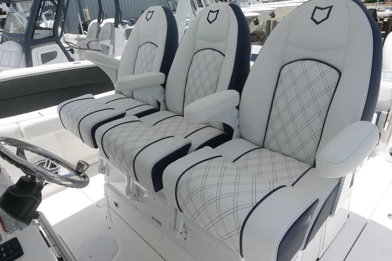  Yacht Photos Pics 2025 Sea Fox 328 Commander boat seats with elegant diamond stitching and armrests.